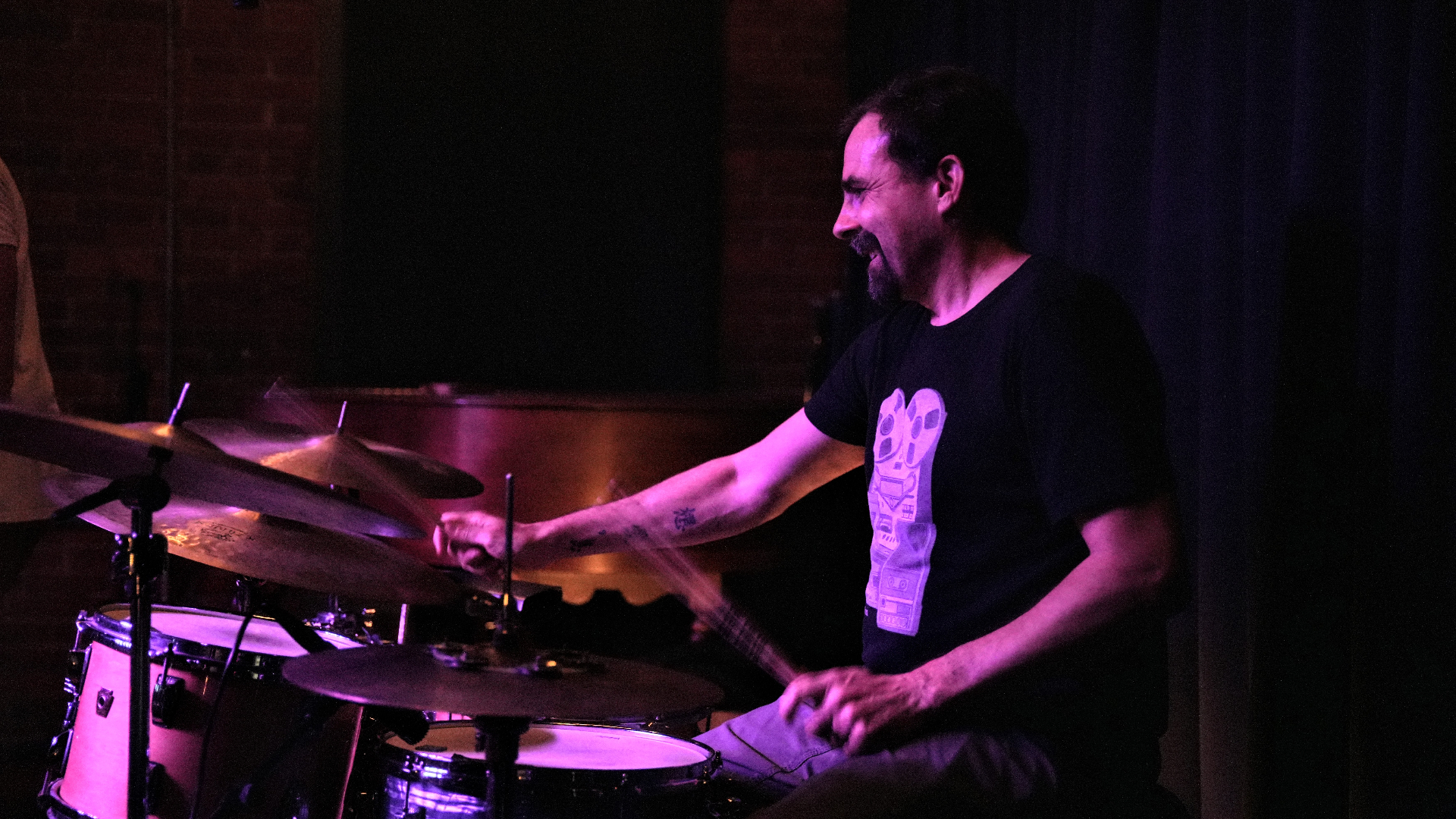 Drummer laughing behind the kit