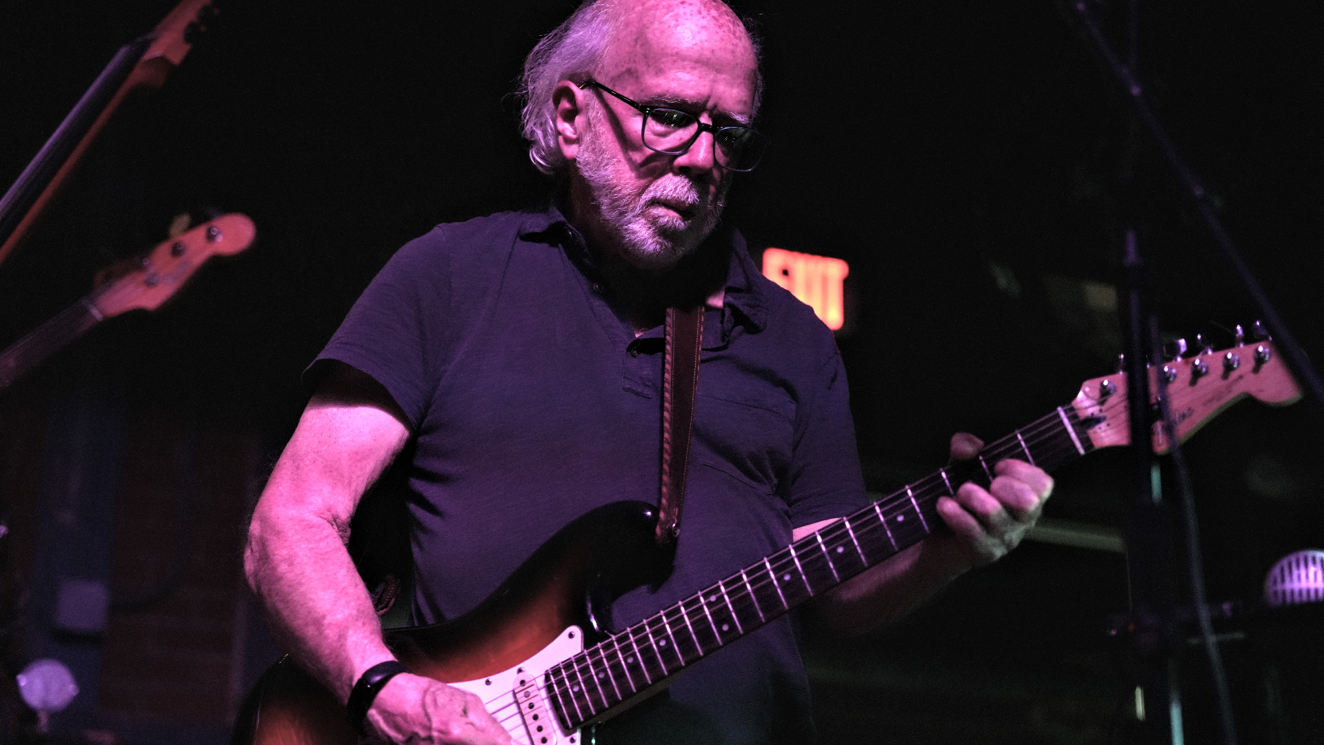 Jim on the Strat under pink light