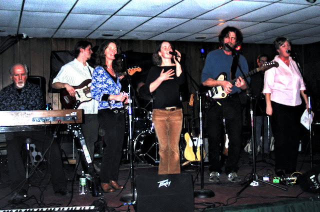 A full stage of singers and players